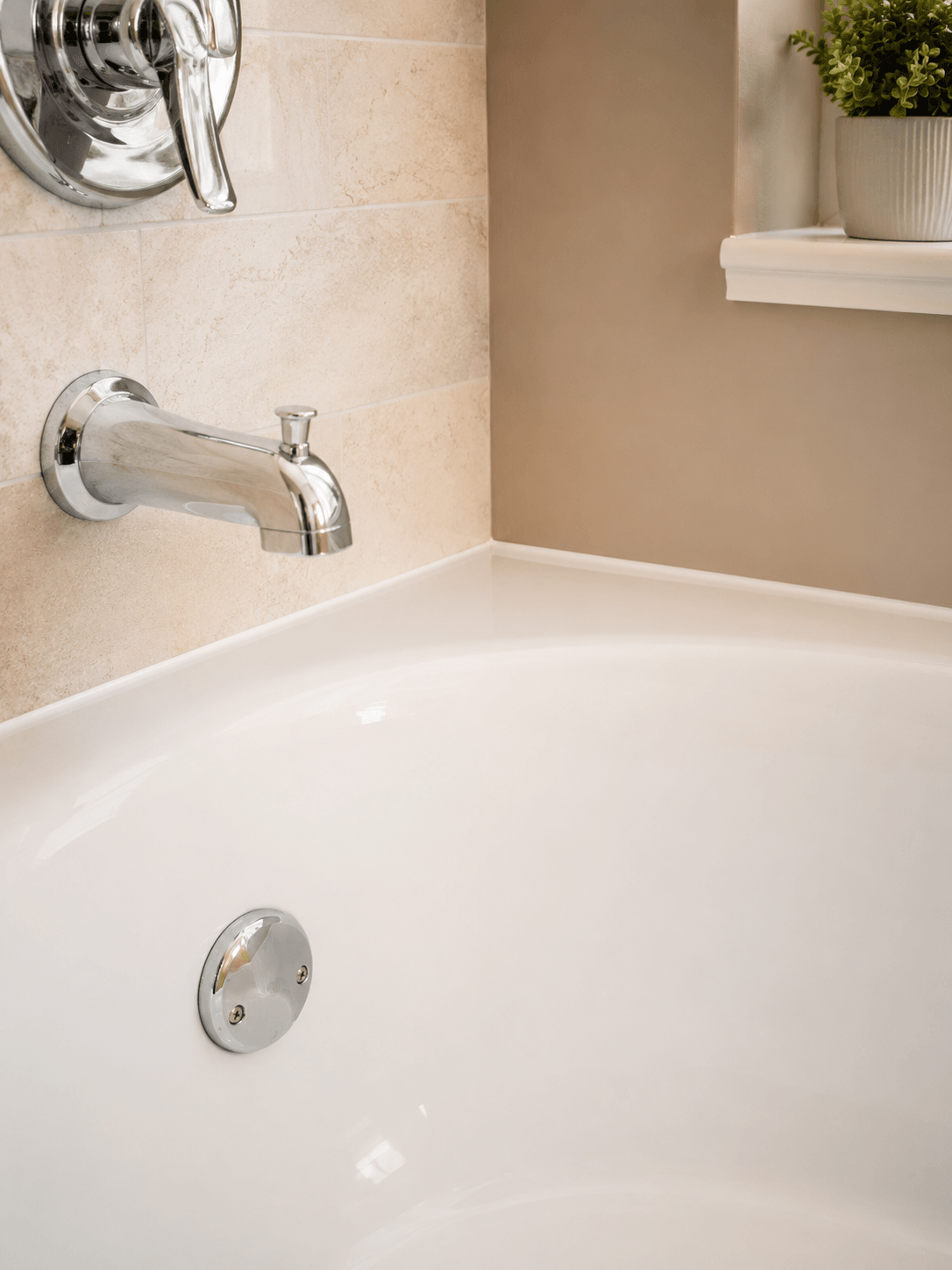 Clean bathtub reglazing detail with polished fixture and refreshed bathroom surface